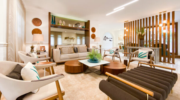 Sala de estar com sofá e poltronas em bege, móveis de alta qualidade, mesa de centro em design moderno em casa à venda na Barra da Tijuca