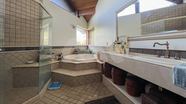 imagem do banheiro da suíte master com hidro da casa duplex com clima rústico à venda na Barra da Tijuca na imobiliária de luxo RJ