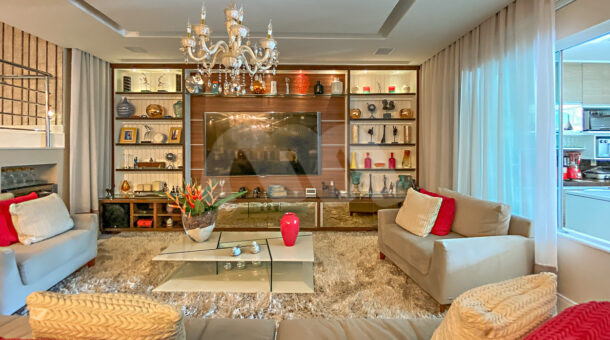 Imagem frontal da sala de Tv da mansão moderna à venda na Muller Imóveis RJ.