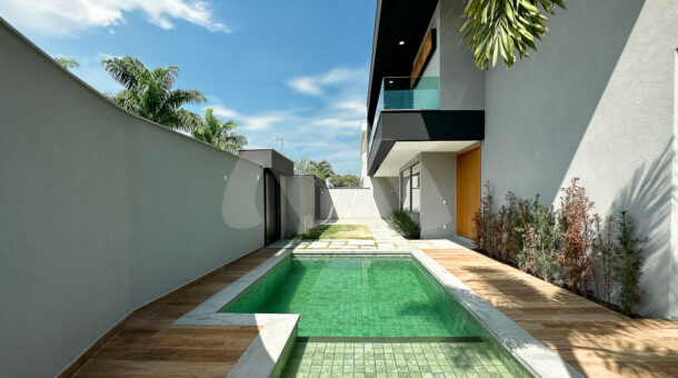 Imagem da área de lazer com piscina da casa à venda em luxuoso condomínio.