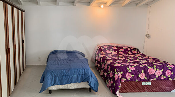 Imagem frontal do quarto com vista com vista das camas do imóvel à venda na Muller Imóveis RJ