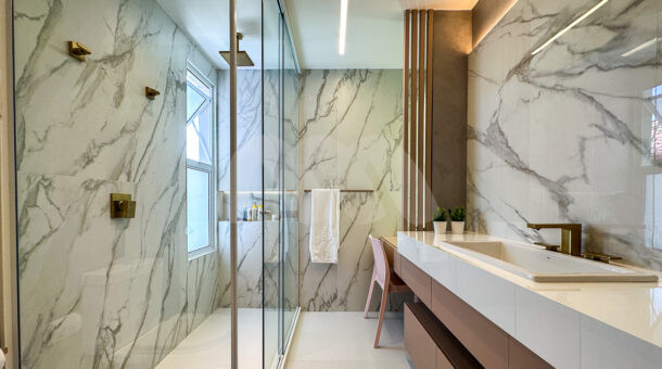 Imagem frontal do banheiro todo detalhado em marmore do imóvel à venda na Muller Imóveis RJ