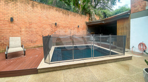 imagem da piscina com deck de madeira da casa duplex próximo ao Gol Clube à venda no Itanhangá
